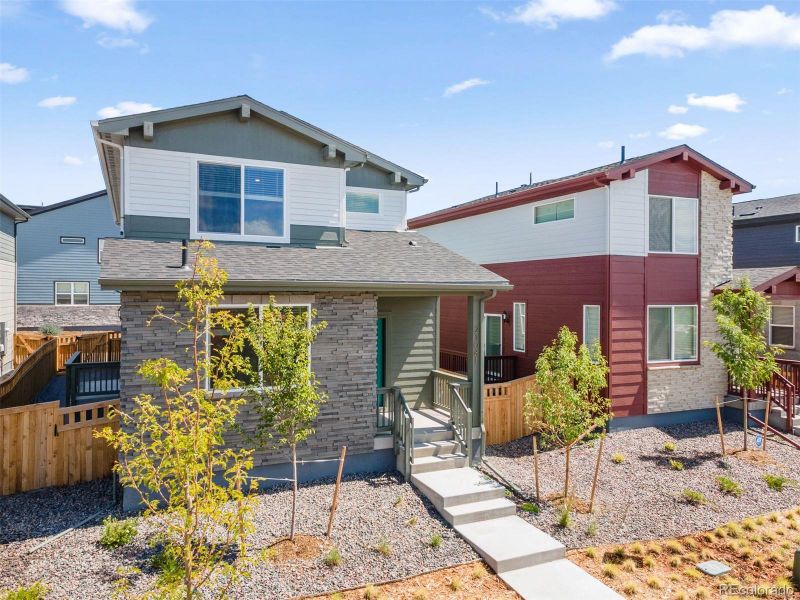 Front exterior of a new home in Woodrose at Painted Prairie, Aurora, CO, highlighting curb appeal (Image 25). Front exterior of a new home in Woodrose at Painted Prairie, Aurora, CO, highlighting curb appeal (Image 25).