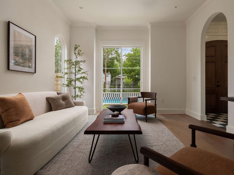 Sun-drenched living space opens to the outdoors, showcasing a bright interior and inviting pool views.