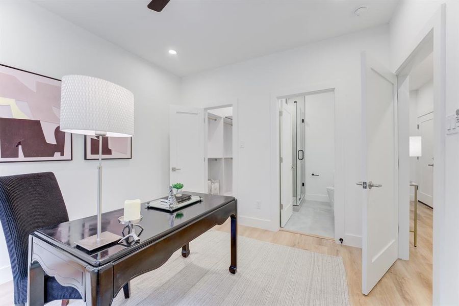 First floor bedroom with en-suite bathroom, ceiling fan, recessed lighting, and luxury vinyl plank flooring.