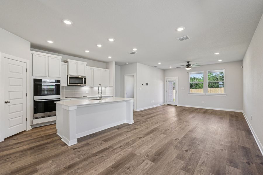 A kitchen with white cabinets.
