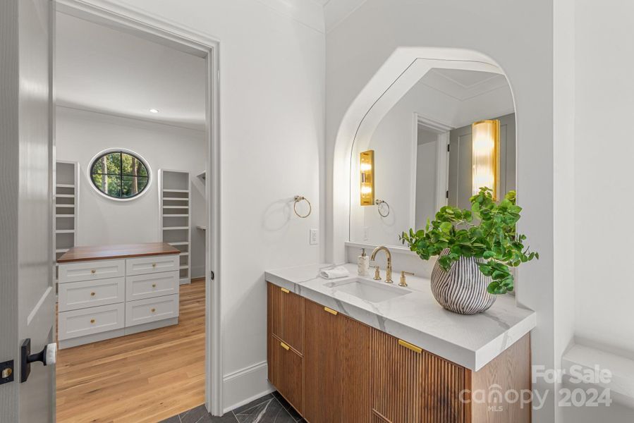 One of two vanities in spa-like bathroom with access to the large primary closet.