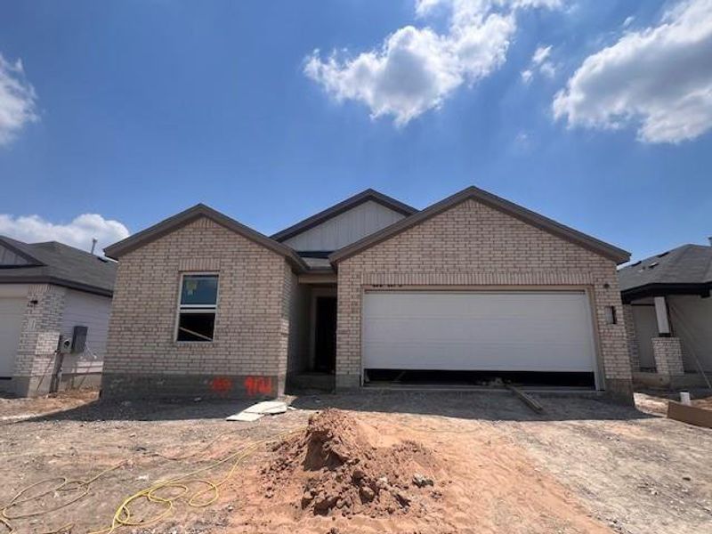 Front exterior of a new home in Marble Creek Crossing, Austin, TX, highlighting curb appeal (Image 1). Front exterior of a new home in Marble Creek Crossing, Austin, TX, highlighting curb appeal (Image 1).