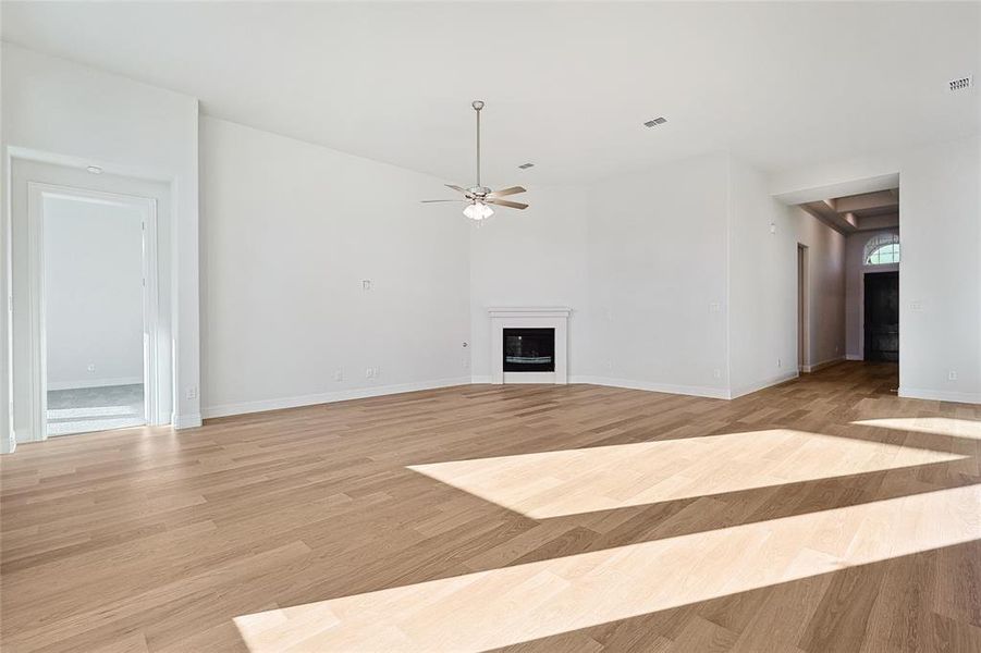 Unfurnished living room featuring light hardwood / wood-style flooring and ceiling fan