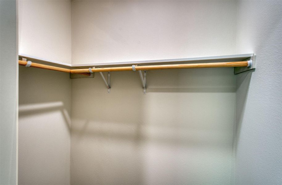 Ample hanging space and shelving offer convenient organization within this well-appointed closet. Ample hanging space and shelving offer convenient organization within this well-appointed closet.