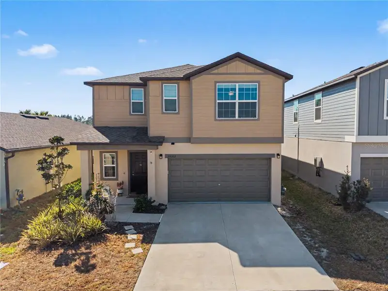 Front exterior of a new home in Two Rivers, Zephyrhills, FL, highlighting curb appeal (Image 21).