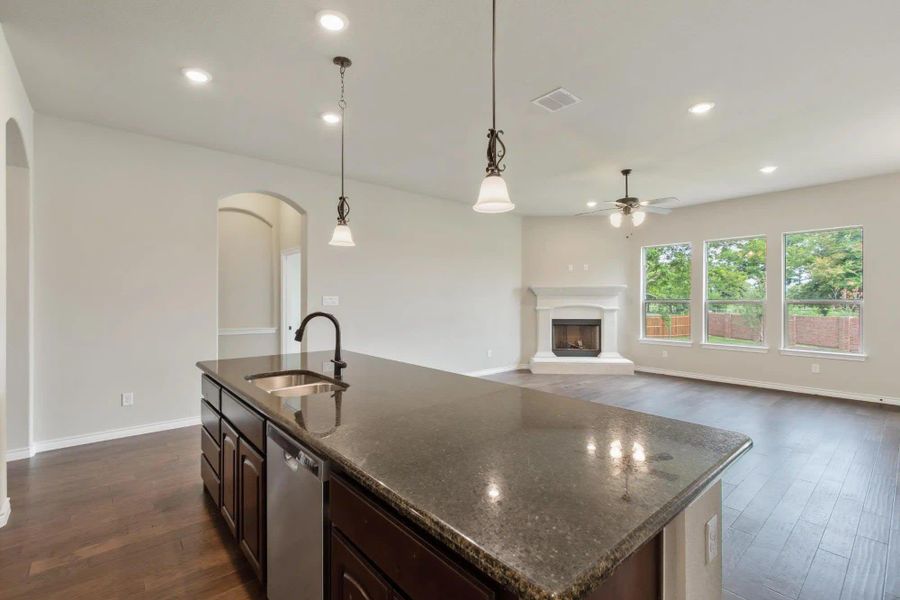 Kitchen & Family Room | Concept 2671 at Mockingbird Hills in Joshua, TX by Landsea Homes