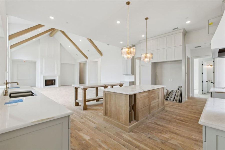 The gourmet kitchen is a true masterpiece with two oversized islands, Cristallo quartz counters, commercial grade Bertazzoni appliances, 48in dual-fuel range with 6 burners plus griddle, double oven and convection, 60in built-in refrigerator and freezer, and range hood with state-of-the-art ventilation system.