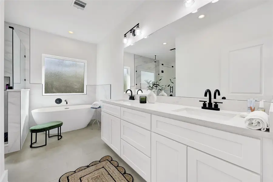 Spa-inspired bath with soaking tub, walk-in shower, and dual vanities.