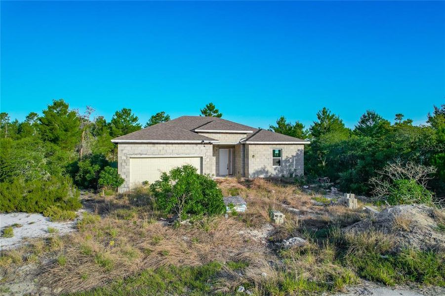 Front exterior of a new home in , Poinciana, FL, highlighting curb appeal (Image 6).