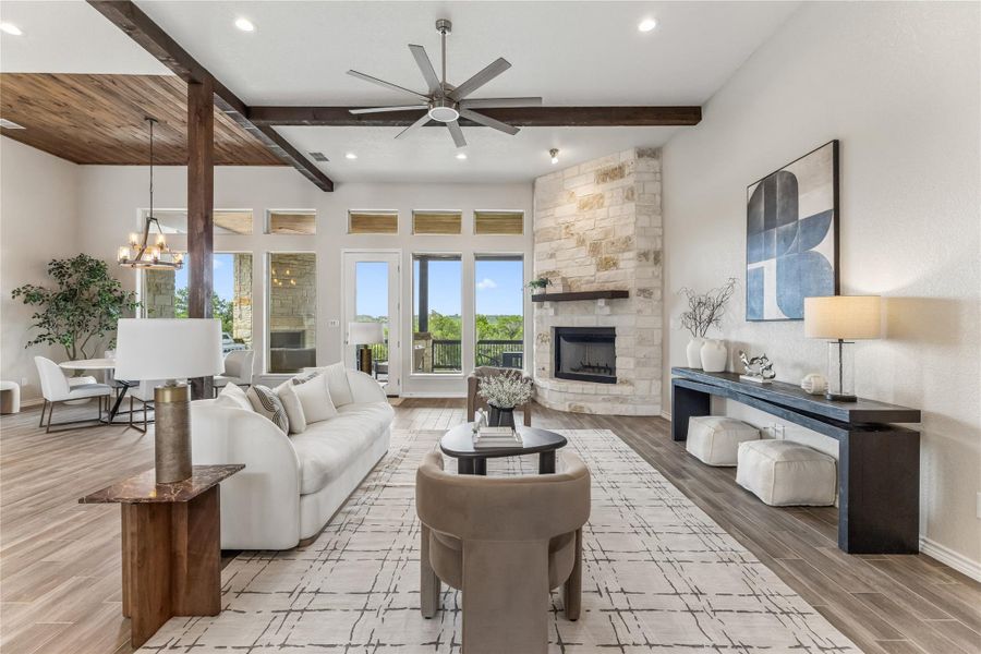 Grand living area with high ceilings, an elegant fireplace, and scenic views invites comfortable entertaining.