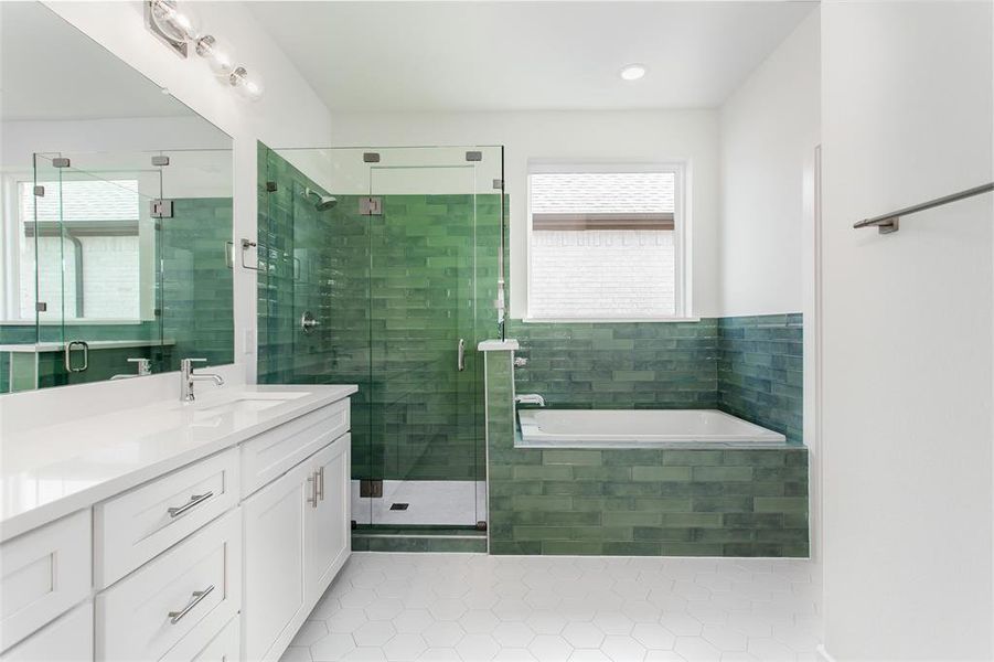 Bathroom with tile patterned flooring, vanity, and shower with separate bathtub