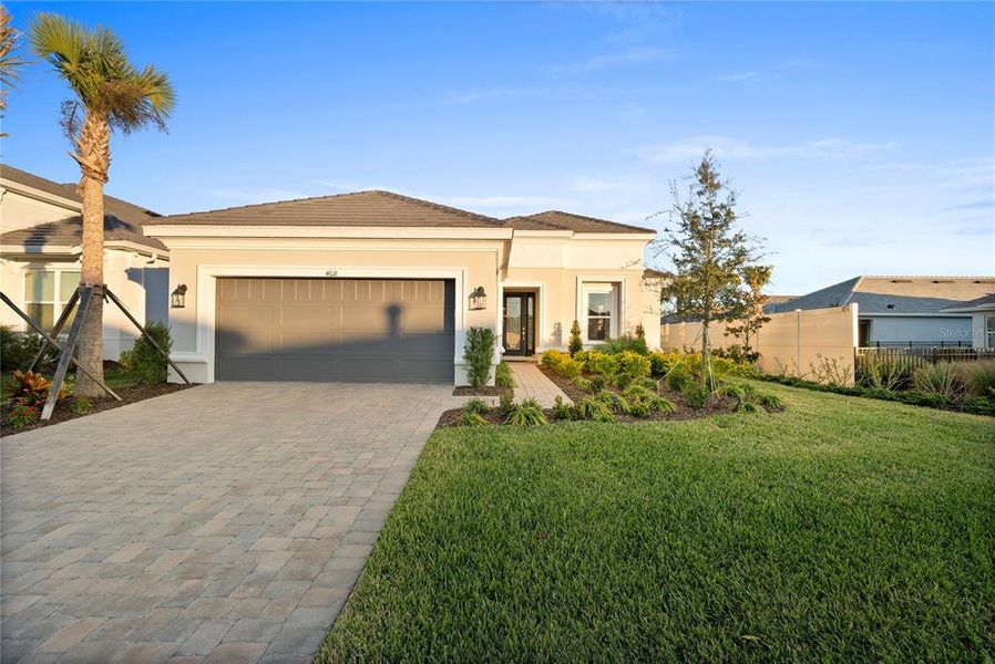 Front exterior of a new home in Esplanade at Wiregrass Ranch, Wesley Chapel, FL, highlighting curb appeal (Image 21).