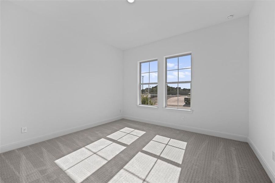 Unfurnished room with light carpet