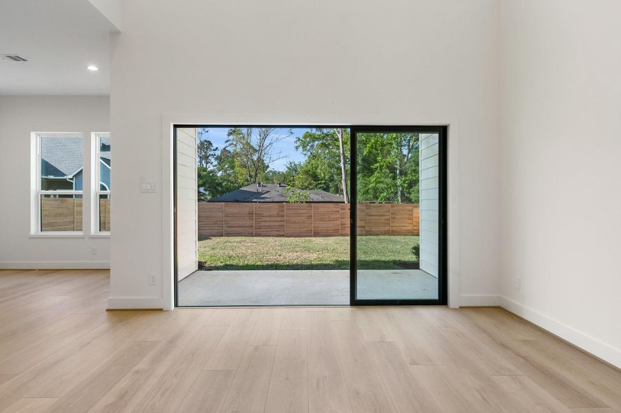 With the sliding doors open, the living space flows effortlessly onto the covered patio, creating a seamless connection to the quiet and generous backyard. With the sliding doors open, the living space flows effortlessly onto the covered patio, creating a seamless connection to the quiet and generous backyard.