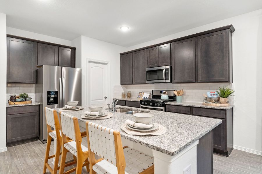 A kitchen with a table and chairs. A kitchen with a table and chairs.