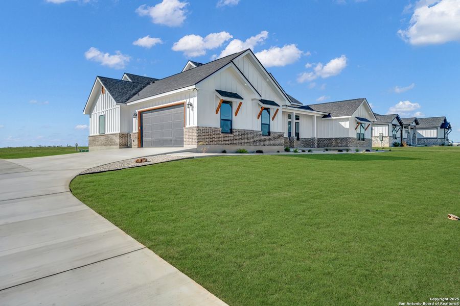 Front exterior of a new home in , La Vernia, TX, highlighting curb appeal (Image 31).