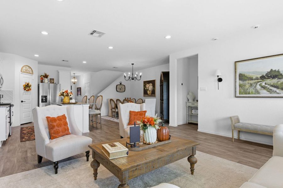 Bright open-concept living area with abundant natural light and warm vinyl wood flooring. Bright open-concept living area with abundant natural light and warm vinyl wood flooring.