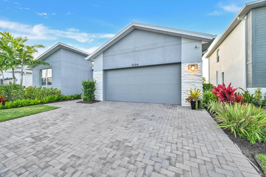 Front exterior of a new home in Tradition - Cadence, Port St. Lucie, FL, highlighting curb appeal (Image 1).
