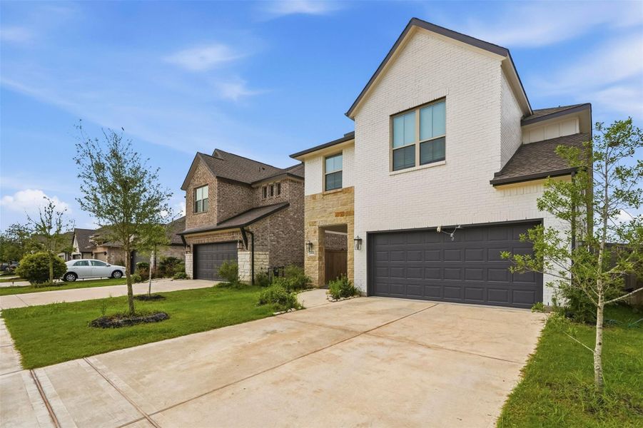 Front exterior of a new home in Candela, Richmond, TX, highlighting curb appeal (Image 21). Front exterior of a new home in Candela, Richmond, TX, highlighting curb appeal (Image 21).