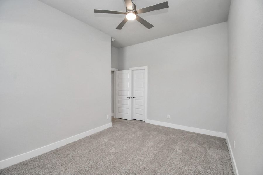 Generously sized secondary bedrooms featuring spacious closets, soft and inviting carpeting underfoot, large windows allowing plenty of natural light, and the added touch of privacy blinds for your personal retreat. Sample photo of completed home with similar floor plan. Actual colors and selections may vary.