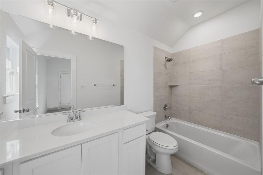 Full bath with vaulted ceiling, shower / tub combination, vanity, and recessed lighting Full bath with vaulted ceiling, shower / tub combination, vanity, and recessed lighting
