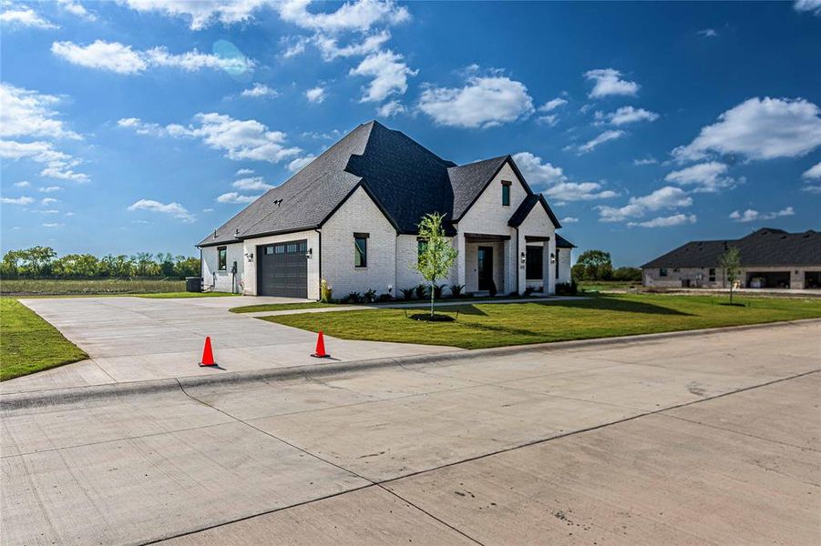Front exterior of a new home in , Caddo Mills, TX, highlighting curb appeal (Image 1).