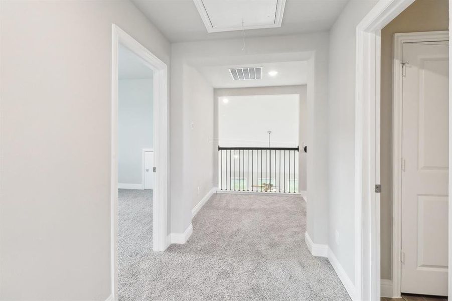 Hall featuring light colored carpet