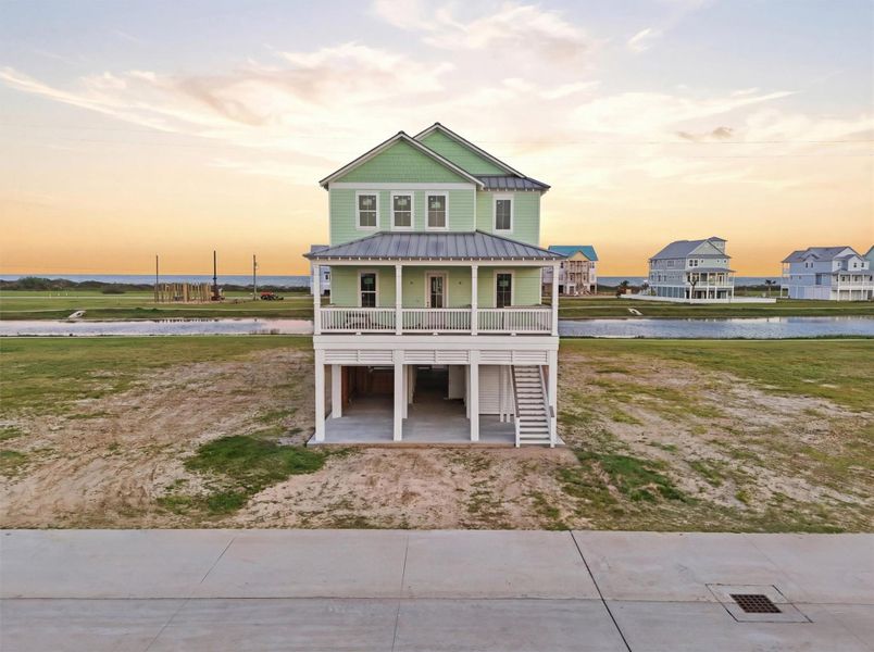 Charming coastal home with a fresh green facade, elevated design, and spacious front porch. Ideal for enjoying serene water views and stunning sunsets. Charming coastal home with a fresh green facade, elevated design, and spacious front porch. Ideal for enjoying serene water views and stunning sunsets.