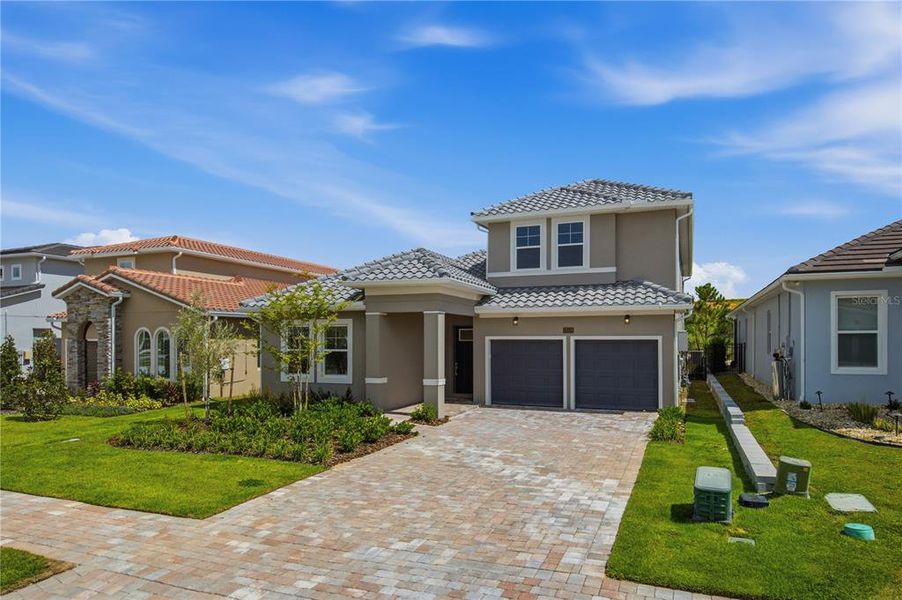 Front exterior of a new home in Bella Collina, Montverde, FL, highlighting curb appeal (Image 26).