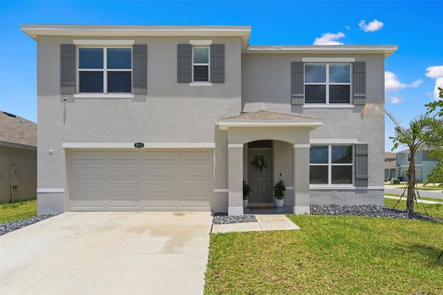Front exterior of a new home in Epperson, Wesley Chapel, FL, highlighting curb appeal (Image 1). Front exterior of a new home in Epperson, Wesley Chapel, FL, highlighting curb appeal (Image 1).