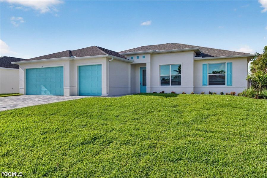 Front exterior of a new home in Cape Coral, Cape Coral, FL, highlighting curb appeal (Image 1). Front exterior of a new home in Cape Coral, Cape Coral, FL, highlighting curb appeal (Image 1).