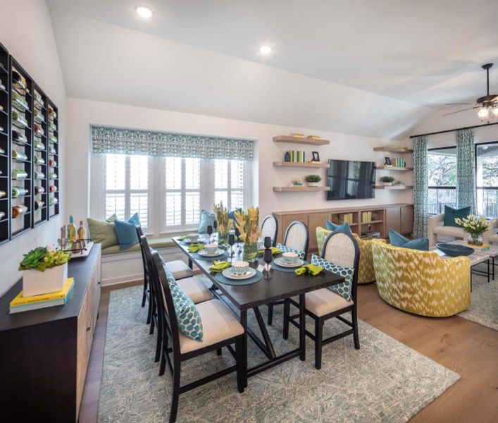 Dining space featuring a ceiling fan, vaulted ceiling, recessed lighting, and wood finished floors