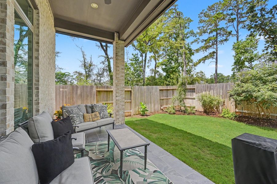 You will be wowed at how pretty this patio and backyard are. Tile flooring has been added to the covered patio with recessed lighting and a ceiling fan. You will be wowed at how pretty this patio and backyard are. Tile flooring has been added to the covered patio with recessed lighting and a ceiling fan.