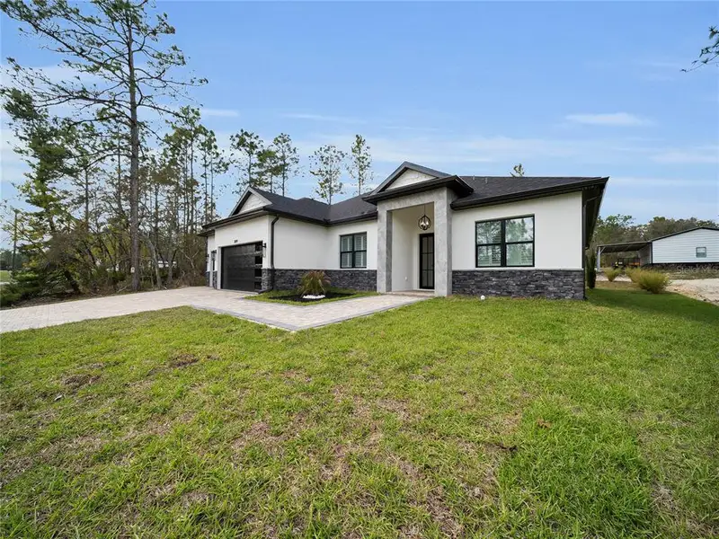 Front exterior of a new home in , Dunnellon, FL, highlighting curb appeal (Image 1). Front exterior of a new home in , Dunnellon, FL, highlighting curb appeal (Image 1).