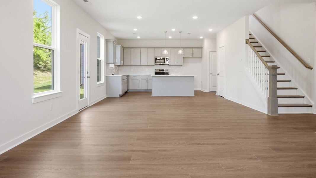 Dining area with view of kitchen and staircase Dining area with view of kitchen and staircase