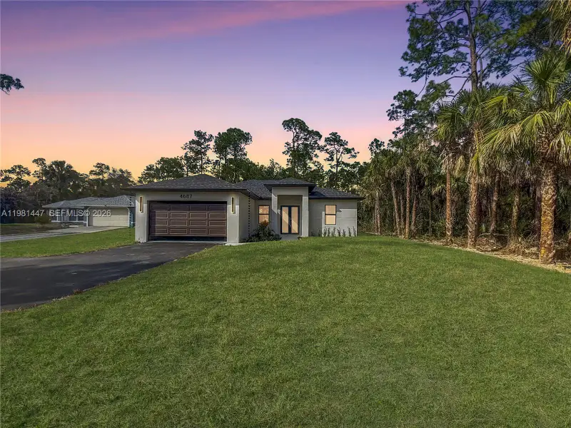 Front exterior of a new home in , Naples, FL, highlighting curb appeal (Image 1). Front exterior of a new home in , Naples, FL, highlighting curb appeal (Image 1).