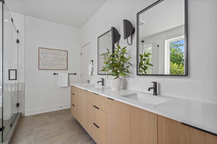 Featuring sleek quartz counters atop a floating vanity with daul sinks. Featuring sleek quartz counters atop a floating vanity with daul sinks.
