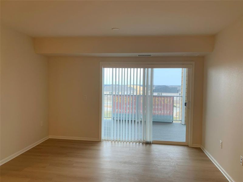 Living room featuring light wood-type flooring and baseboards