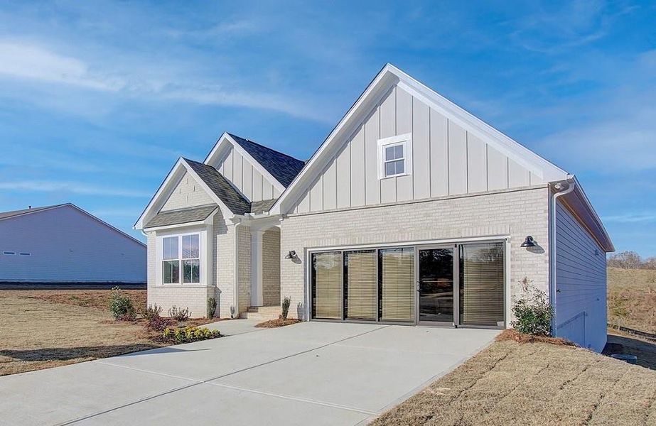 Front exterior of a new home in Courtyards at Traditions, Cumming, GA, highlighting curb appeal (Image 25).