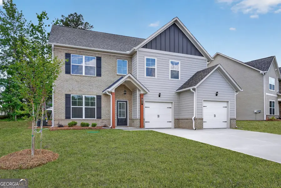 Front exterior of a new home in The Fairways at Mirror Lake, Villa Rica, GA, highlighting curb appeal (Image 2). Front exterior of a new home in The Fairways at Mirror Lake, Villa Rica, GA, highlighting curb appeal (Image 2).