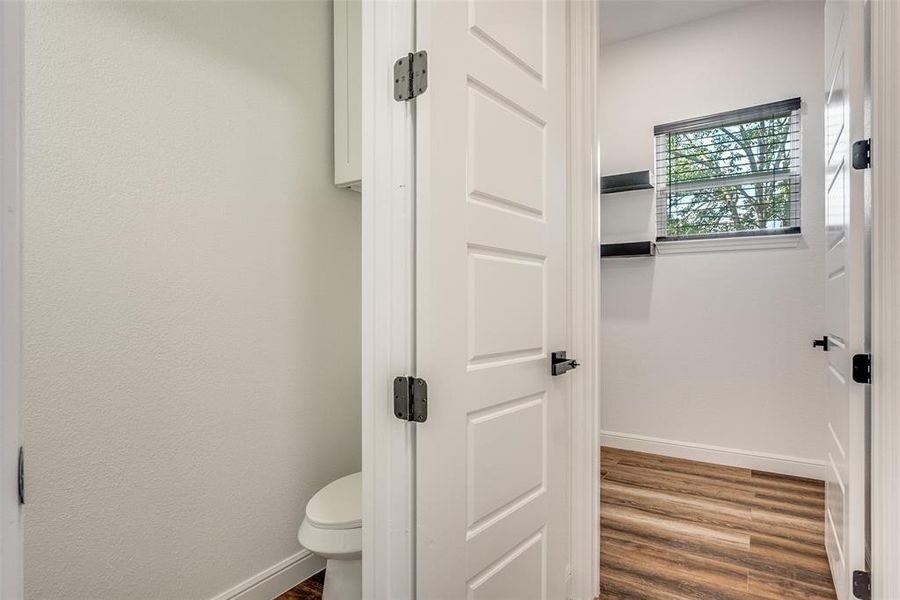 Bathroom featuring baseboards and wood finished floors