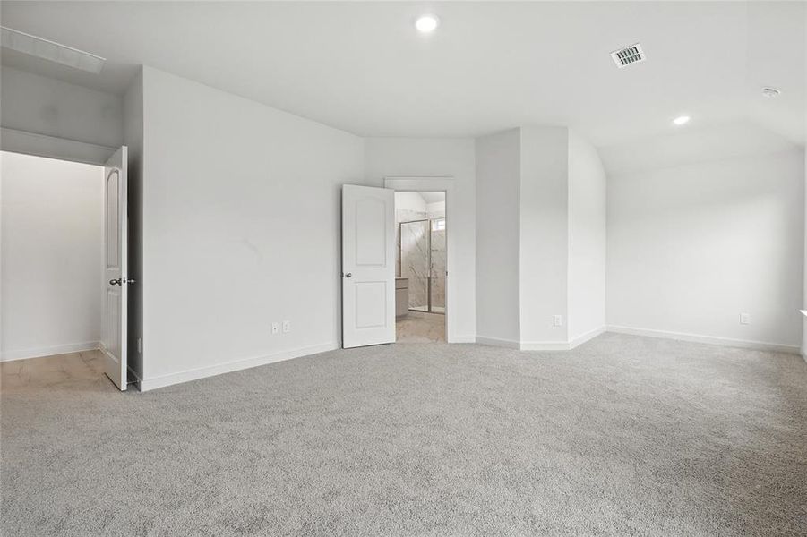 Unfurnished bedroom featuring carpet floors, recessed lighting, and ensuite bath