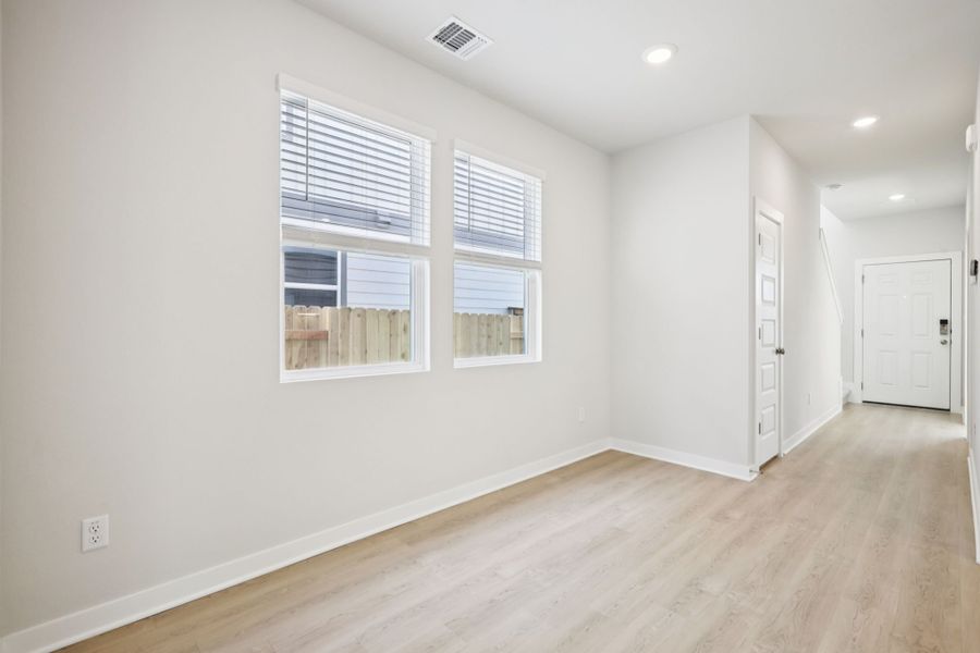 A room with a wood floor and white walls.