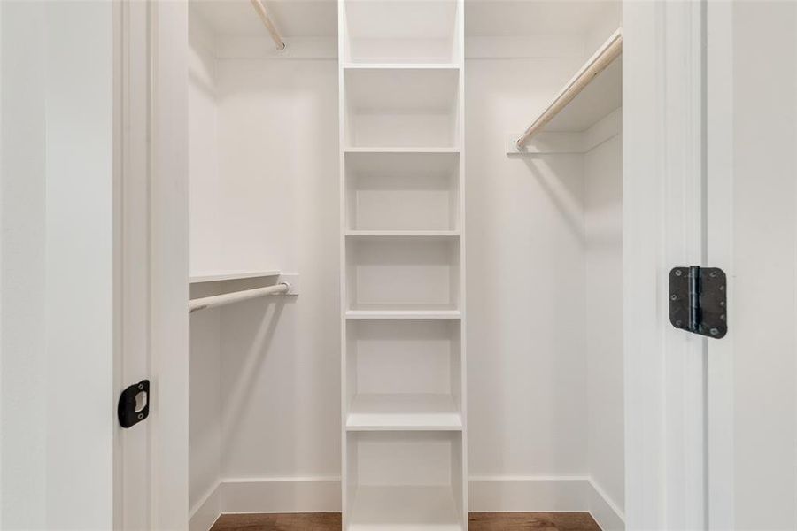 Spacious closet featuring hardwood / wood-style flooring