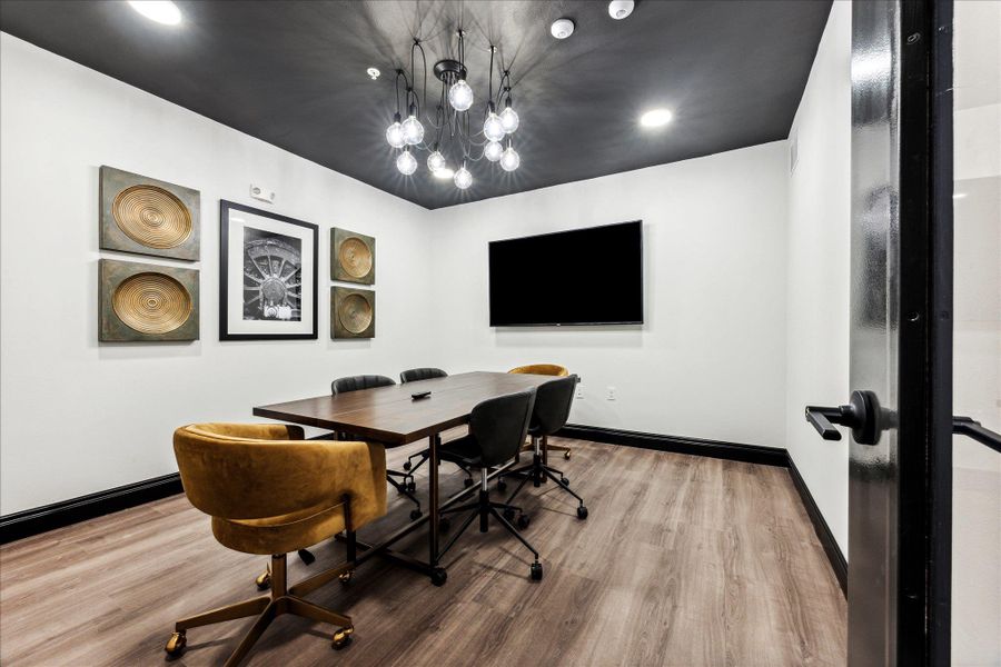 A well-lit meeting room featuring rich wood flooring and modern overhead lighting. A well-lit meeting room featuring rich wood flooring and modern overhead lighting.
