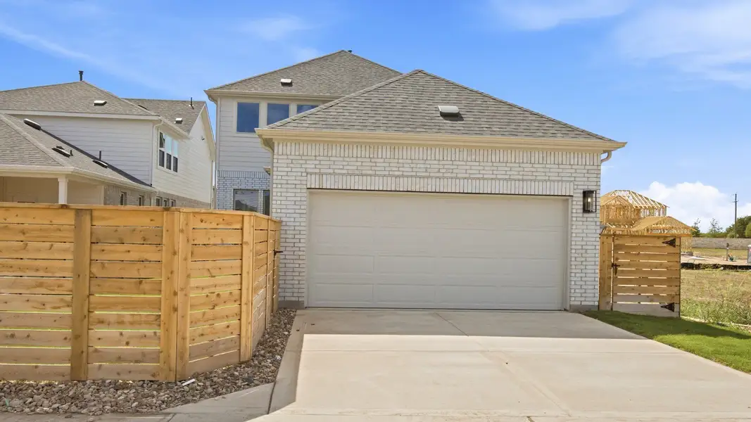 Front exterior of a new home in Flora, Hutto, TX, highlighting curb appeal (Image 2). Front exterior of a new home in Flora, Hutto, TX, highlighting curb appeal (Image 2).