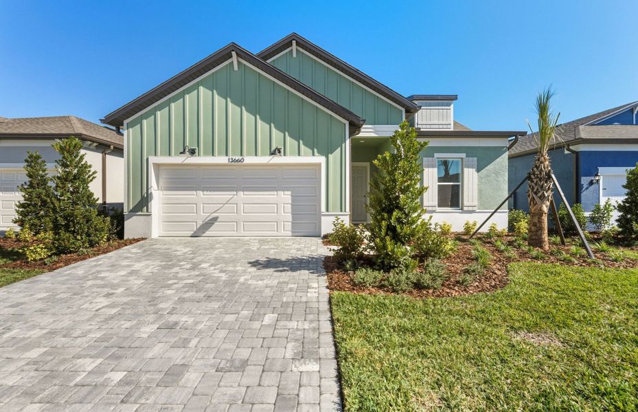 Front exterior of a new home in Del Webb River Reserve, Spring Hill, FL, highlighting curb appeal (Image 15).