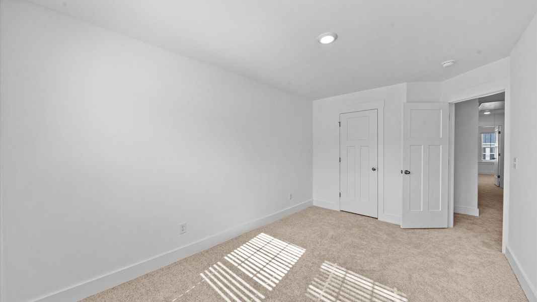 Accomplished design shines in this carpeted bedroom with a functional walk-in closet Accomplished design shines in this carpeted bedroom with a functional walk-in closet