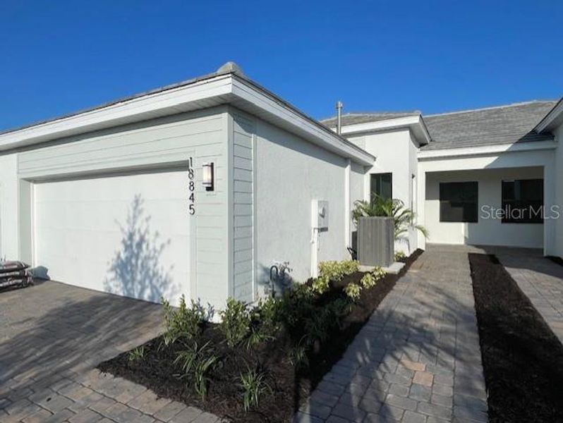 Front exterior of a new home in Del Webb Catalina, Lakewood Ranch, FL, highlighting curb appeal (Image 1). Front exterior of a new home in Del Webb Catalina, Lakewood Ranch, FL, highlighting curb appeal (Image 1).