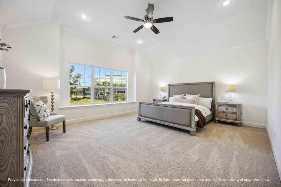 Step into a primary suite that lives like a luxury retreat—soaring ceilings, soft carpet underfoot, and a wall of windows bringing the outside in.